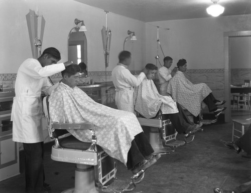 Students getting haircut in barbershop