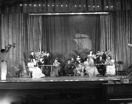 Students in costumes performing on stage