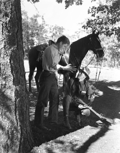 Two men converse in forest