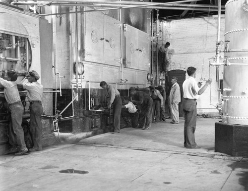 Students examining parts of boiler