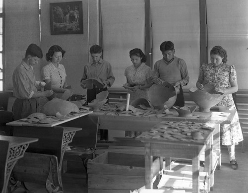 Students reconstructing clay pots