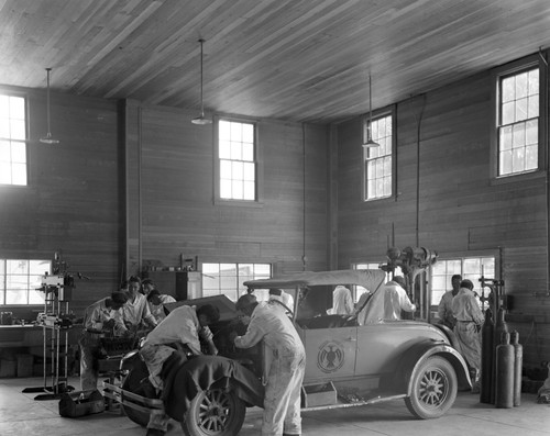 Students repair cars in auto shop