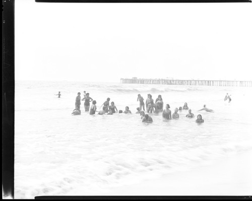 Students swimming and playing at beach