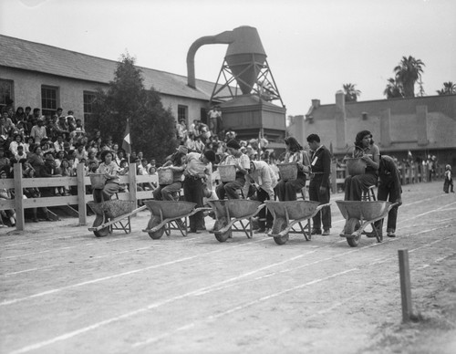 Students participating in wheelbarrow race