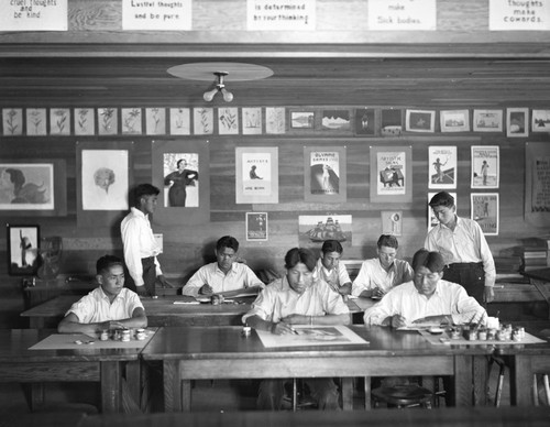 Students work on paintings in classroom