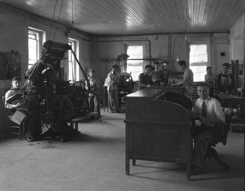 Students work in old print shop on Sherman campus