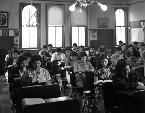 Students doing schoolwork at their desks