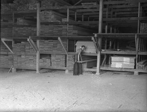 Student selecting lumber from rack