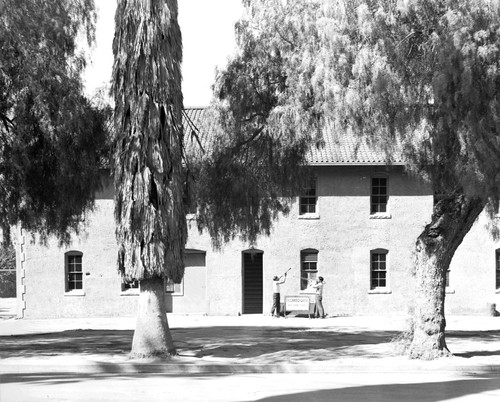 Students playing instruments in front of building