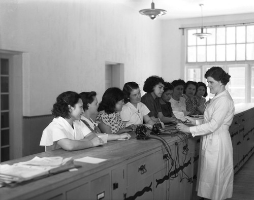 Students wait at counter in an office