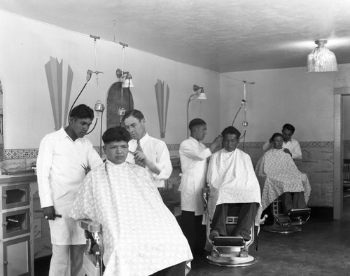 Students getting haircut in barbershop