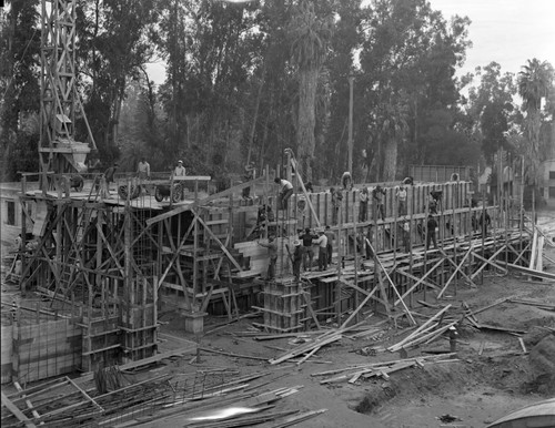 Construction workers constructing building