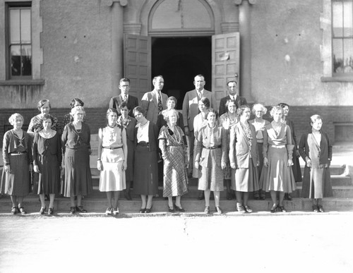 Faculty members in front of main school building