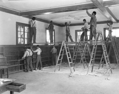 Students painting interior of building