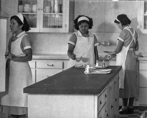 Three women cooking in kitchen