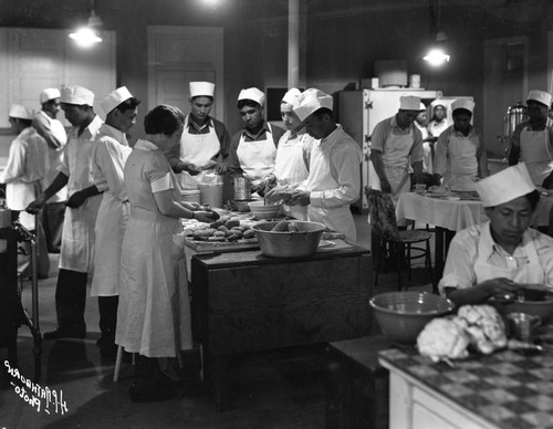 Cooks making bread in kitchen