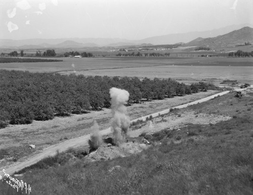Photograph of an explosion in farm field