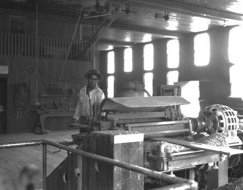 Student using wood planer in shop class