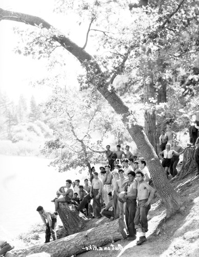 Students posing for photograph next to lake