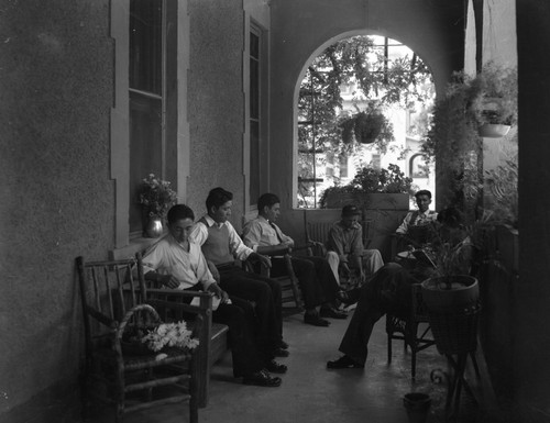 Students sitting outside on porch