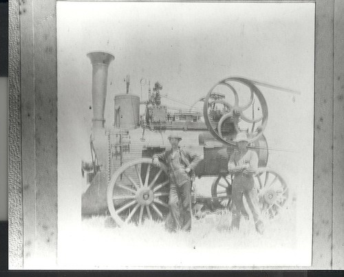 J. Berry & J.K. Jefferson stand beside a threshing (?) machine, Castroville field, in California, LH Photo 378 © California Artichoke Advisory Board, Castroville, California