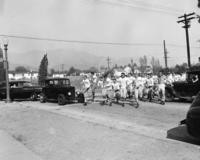 1940s - Teenage Boys in Football. Uniforms Cross the Street