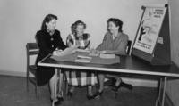1940s - Two unidentified BUSD staff at a desk with a BUSD student