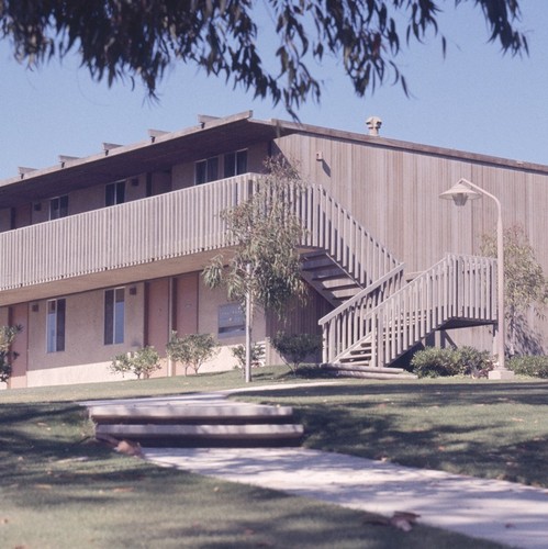 Residential Apartments, Phase One: exterior: front of one building showing balconies and stairs