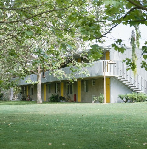 Residential Apartments, Phase One: exterior: front of one building showing balconies and stairs