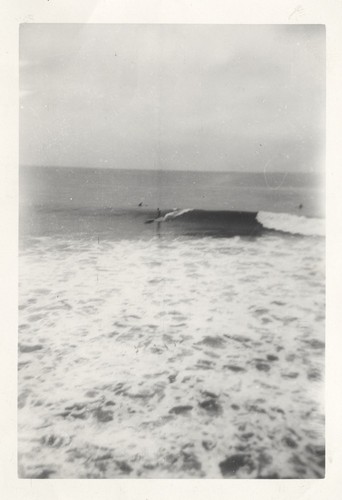 Unidentified surfer at the river mouth