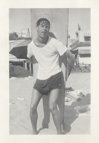 James Alumbaugh with surfboard at Cowell Beach