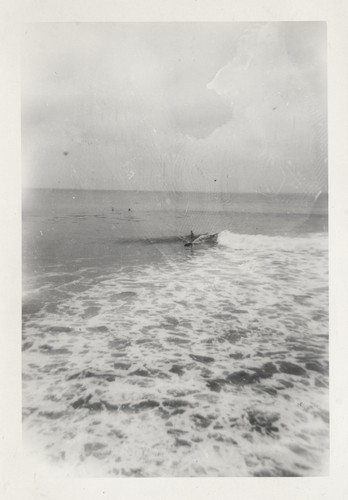 Unidentified surfer at the river mouth