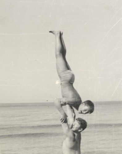 Lloyd Hooper holding Harry Murray overhead at Cowell Beach