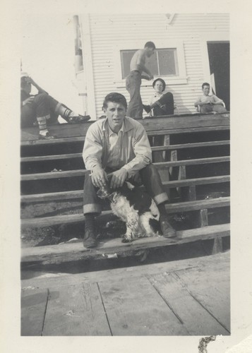 Julio Ghidnelli with dog and others at the clubhouse