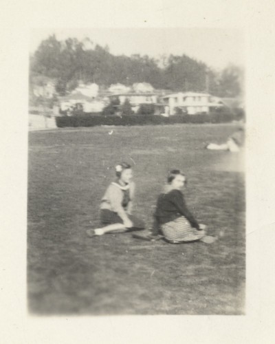 Two unidentified girls on lawn