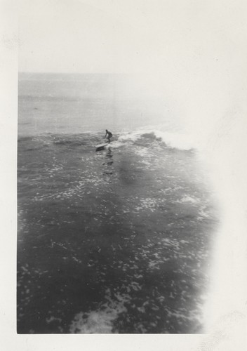 Unidentified surfer at the river mouth