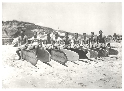 Santa Cruz Surfing Club group portrait: Alex Hokamp, Rich Thompson, Fred Hunt, Buster Steward [?], "Pinky" Pedemonte, Tommy Roussel [?], Blake Turner, Harry Murray, Don ""Bosco"" Patterson