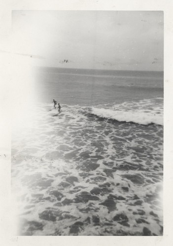 Two unidentified surfers at the river mouth