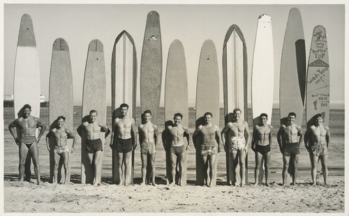 Santa Cruz Surfing Club members Don "Bosco" Patterson, Harry Murray, Rich Thompson, Alex Hokamp, Blake Turner, Bill Grace, Dave "Buster" Steward, Fred Hunt, Harry Mayo, Alexander "Pinky" Pedemonte, and Tommy Roussel at Cowell Beach