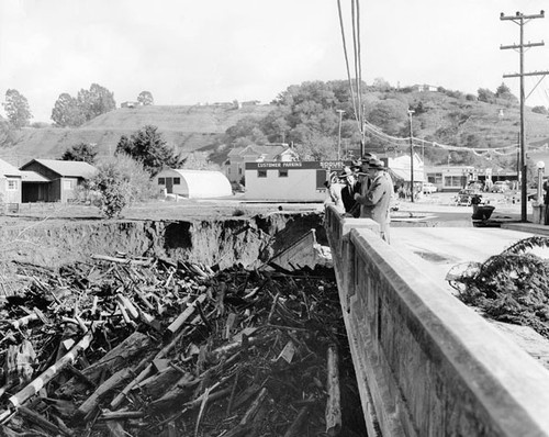 Officials examining the flood-damaged Soquel Bridge