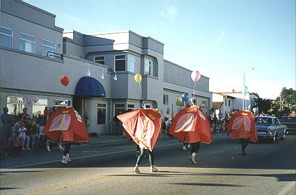 People in tents march in holiday parade