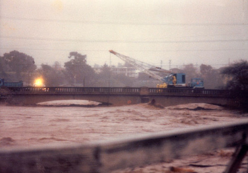 City workers using a crane on the Riverside Avenue bridge