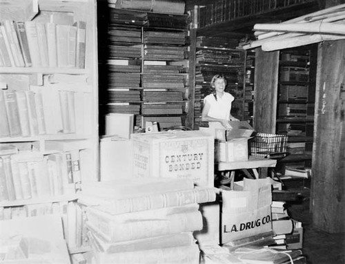 Pat Keller moving materials in the basement of the Santa Cruz Carnegie (Main) Library