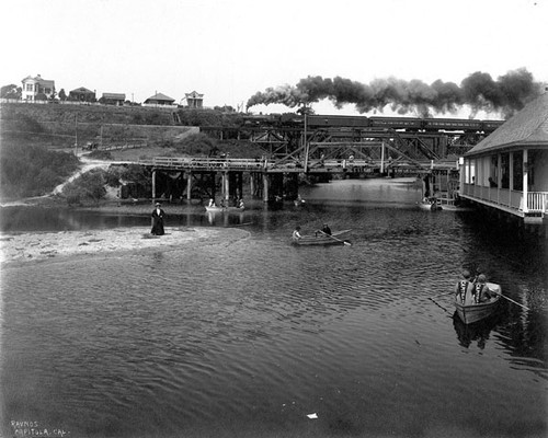 Boaters on Soquel Creek with train trestle