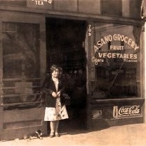 Sakae "Mary" Asano in front of family store on Myrtle