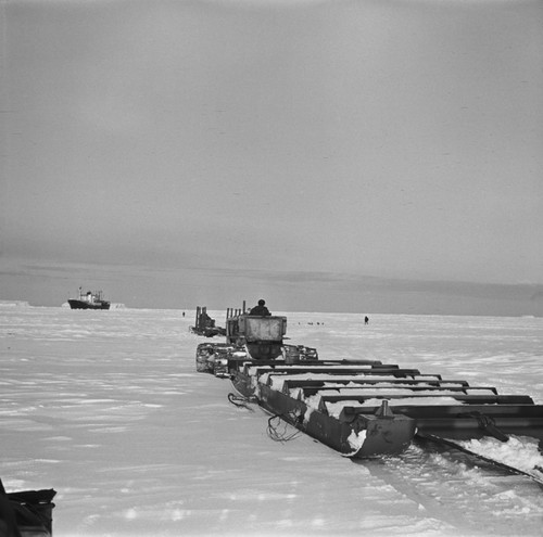 Tractors and heavy sledge coming to Ob ship for unloading