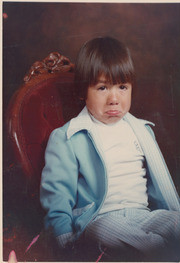 Child sitting for a portrait, East Los Angeles, California