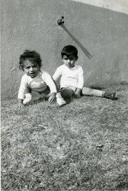 Two Mu√±oz brothers sitting on the grass, East Los Angeles, California
