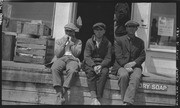 Three men outside a store at Willow Camp