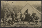 Twelve men in front of a tent